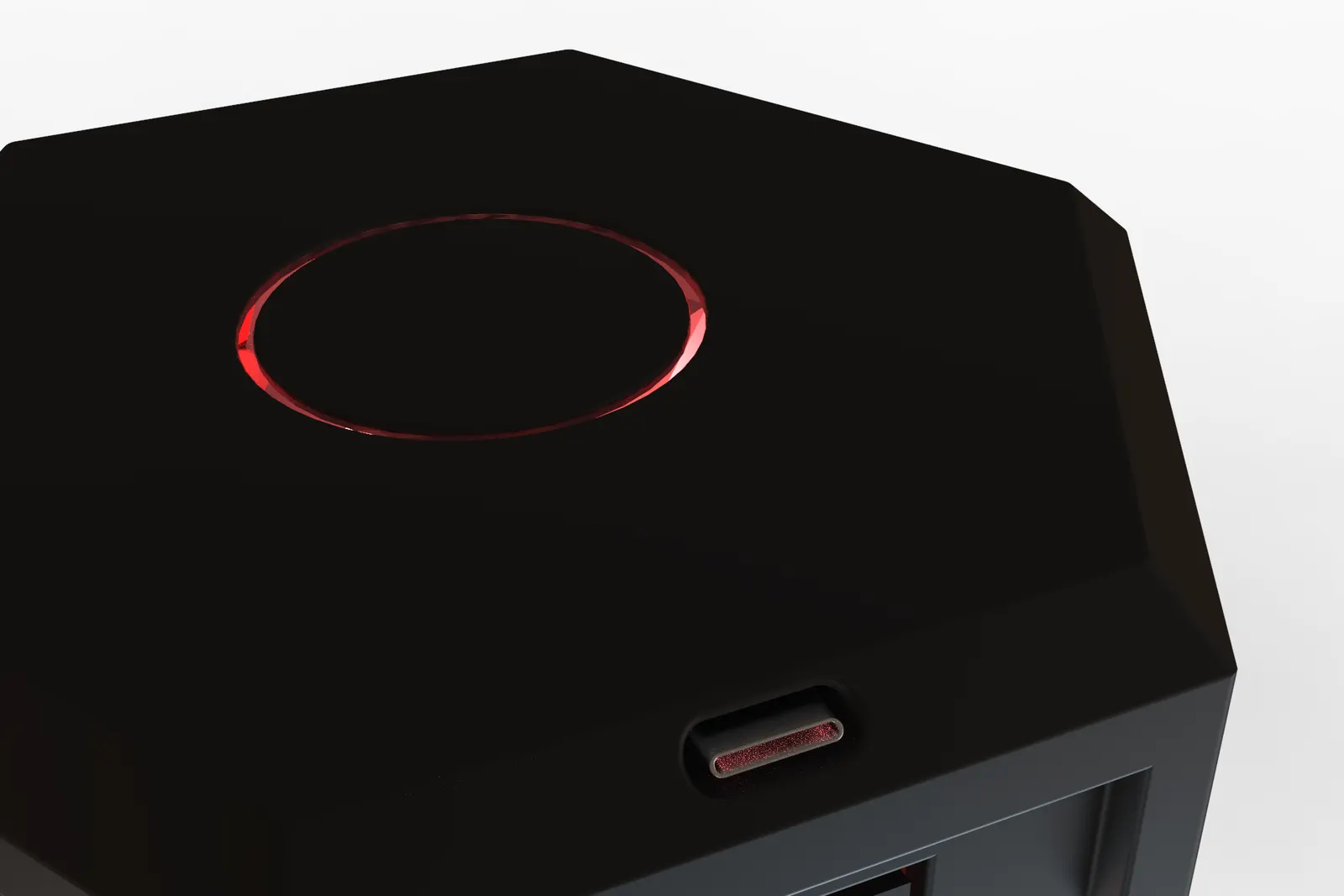 Close detail of the closed dice box lid, showing the illuminated red ring inset into the surface and a small port on the chamfered edge.
