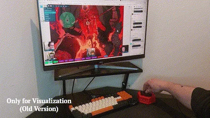 A hand rolling a die from the physical dice box on a desk, with the result appearing moments later in the virtual tabletop session on the monitor above.